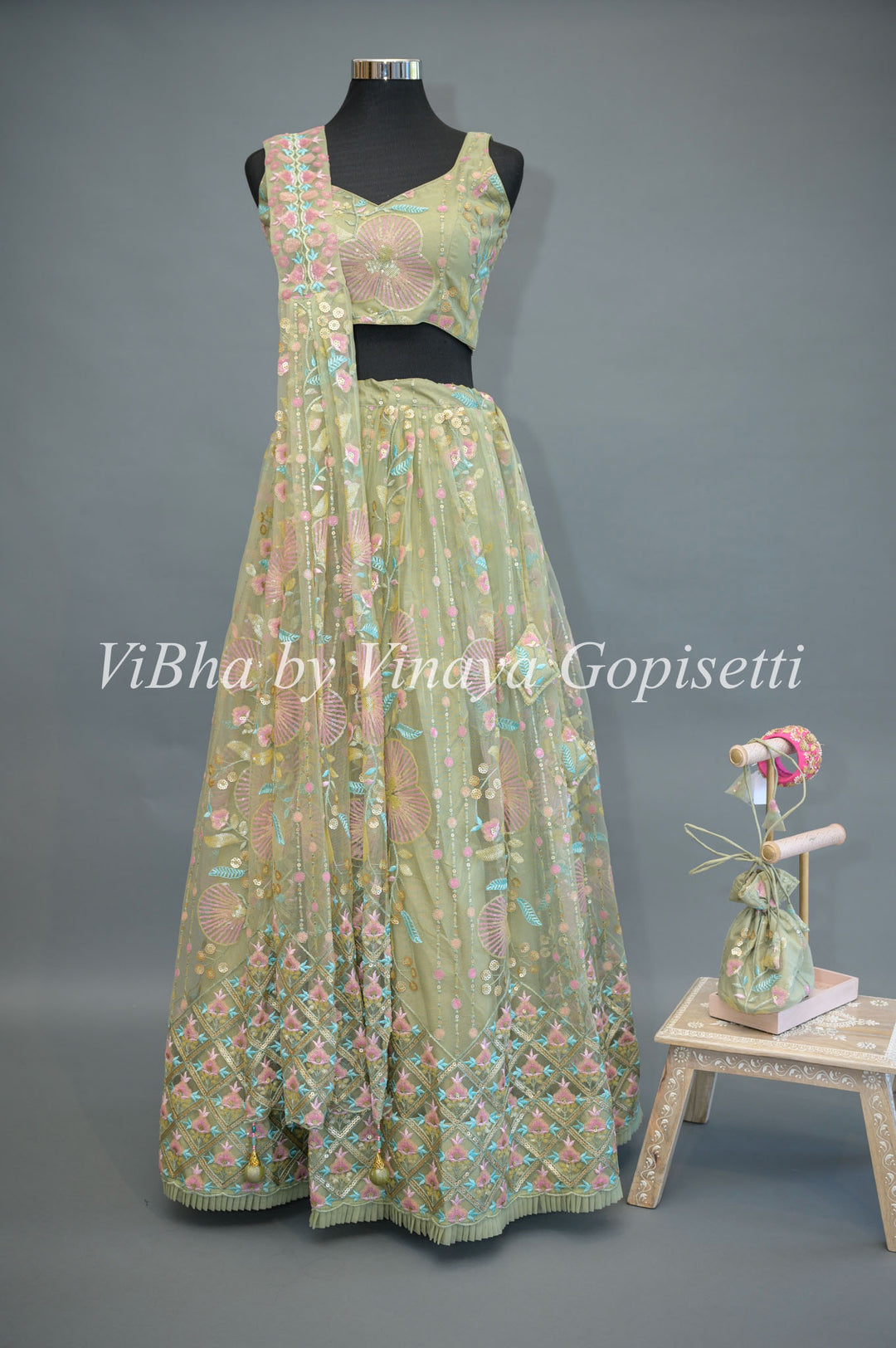 Pastel Green Net embroidered Lehenga Set With Sleeveless Blouse