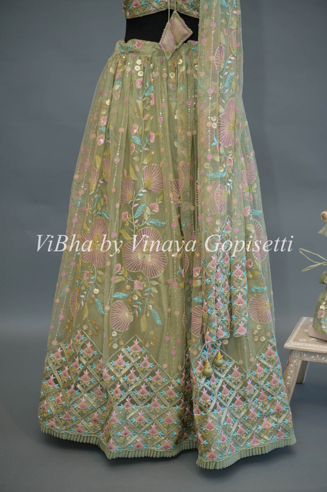 Pastel Green Net embroidered Lehenga Set With Sleeveless Blouse