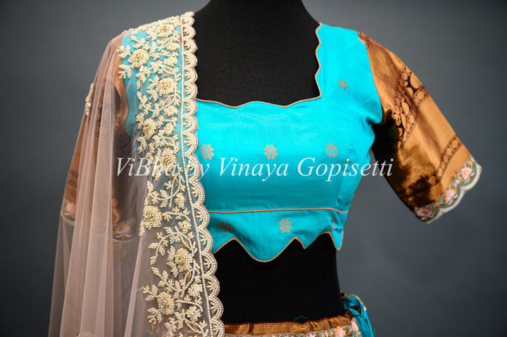 Dark Sky Blue and Brown Gadwal Silk Lehenga with Embroidered Borders And Peach Net Embroidered  Dupatta