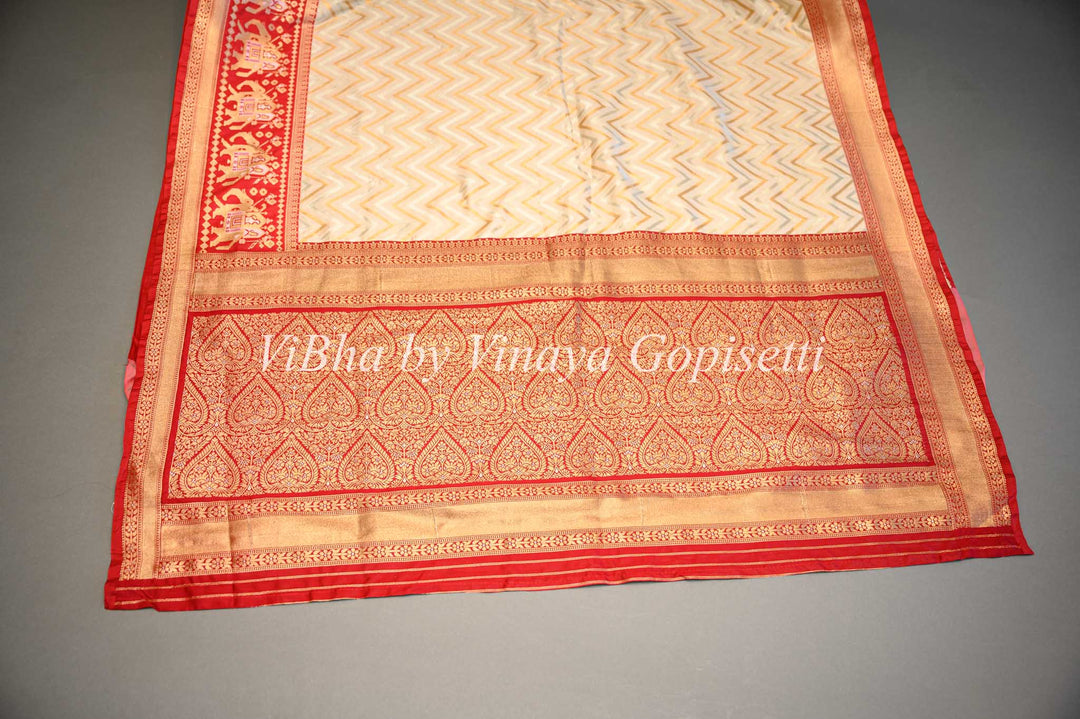 Butter Cream And Dark Red Banarasi Katan Silk Saree And Blouse With Patola Borders and Pallu.