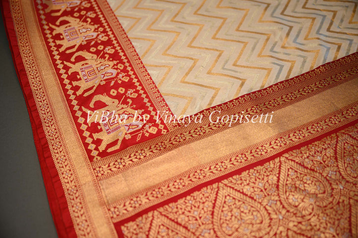 Butter Cream And Dark Red Banarasi Katan Silk Saree And Blouse With Patola Borders and Pallu.