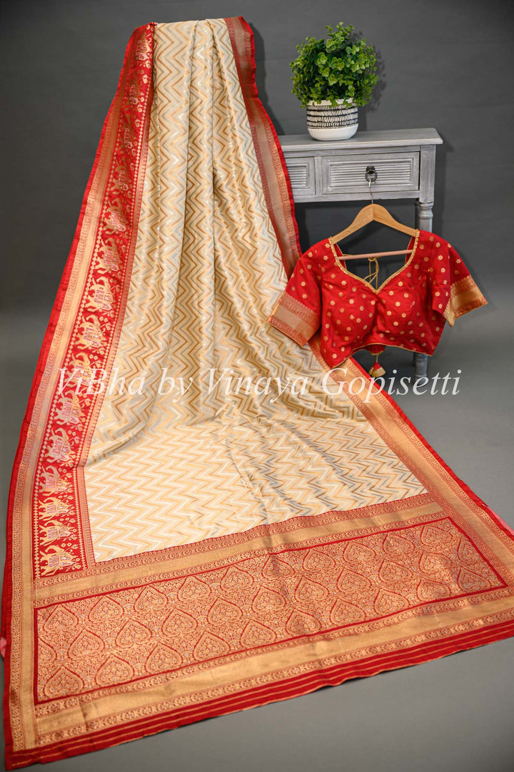 Butter Cream And Dark Red Banarasi Katan Silk Saree And Blouse With Patola Borders and Pallu.