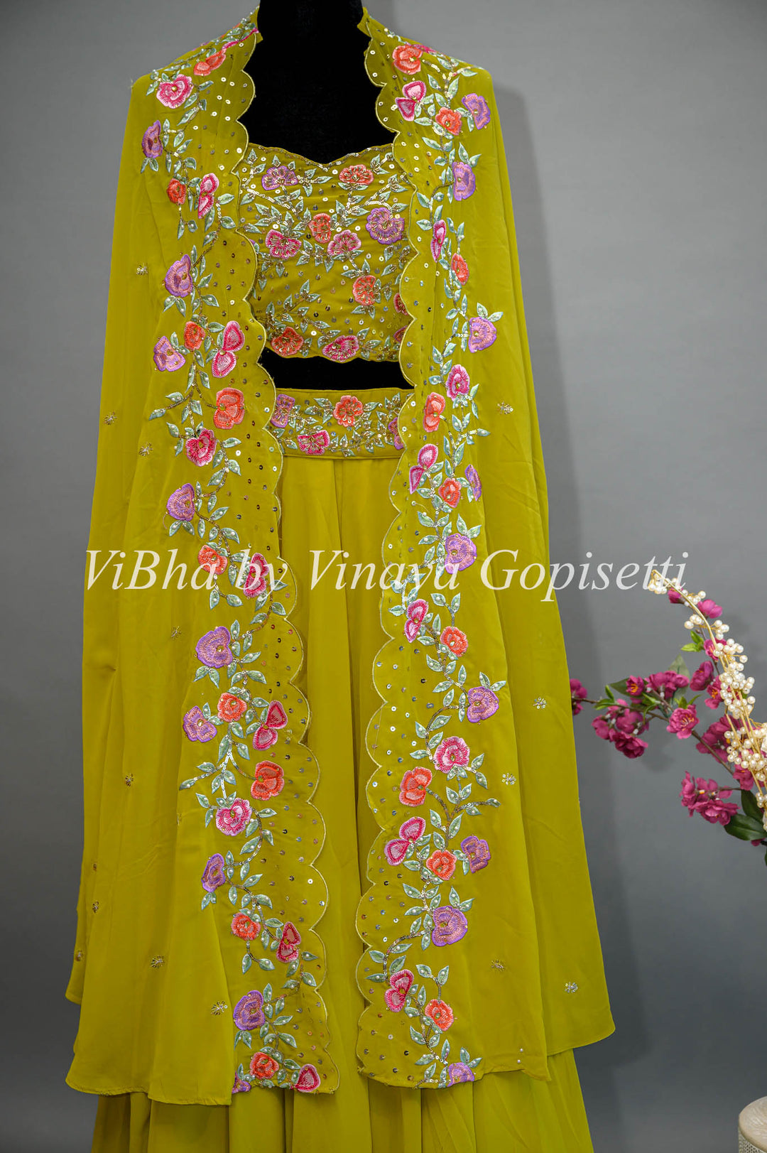 Citrus Green Lehenga with Embroidered Sleeveless Blouse and detachable Cape