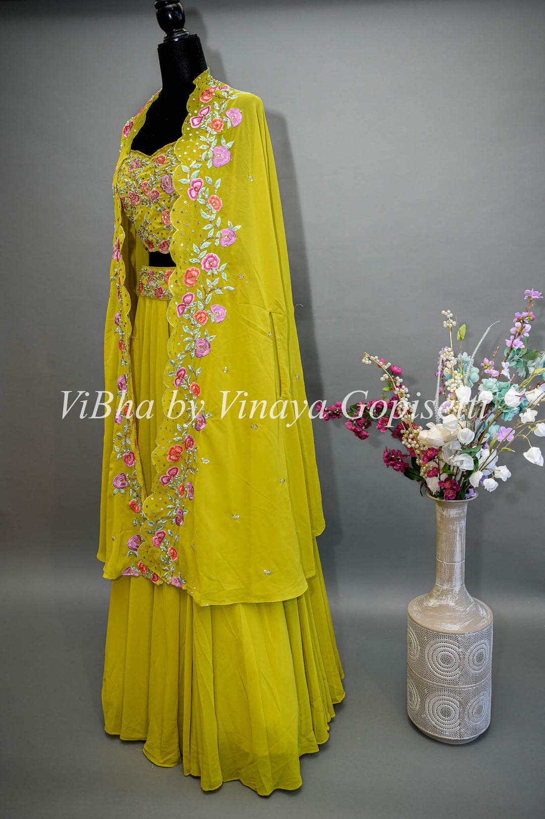 Citrus Green Lehenga with Embroidered Sleeveless Blouse and detachable Cape