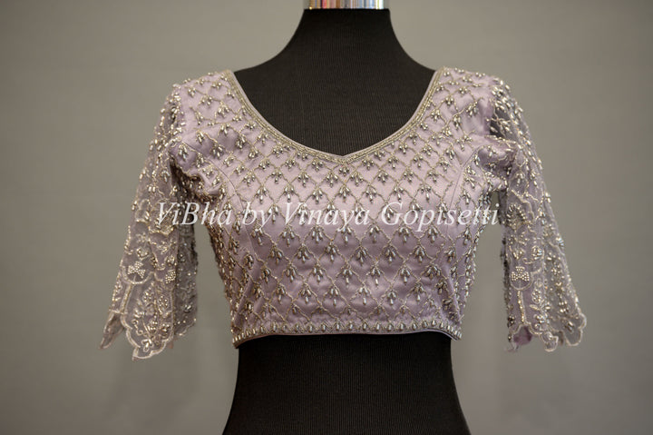 Pastel Lavender Net Blouse With Silver Zari And Crystal Embroidery.