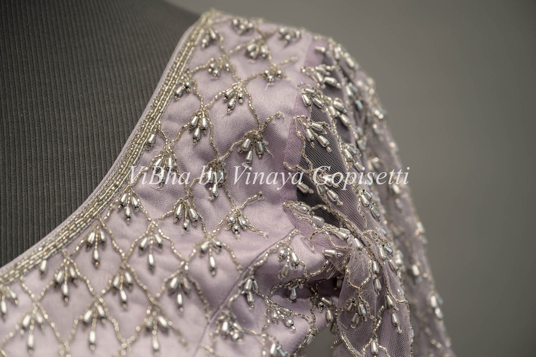 Pastel Lavender Net Blouse With Silver Zari And Crystal Embroidery.