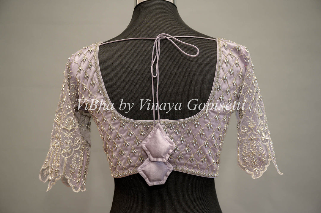 Pastel Lavender Net Blouse With Silver Zari And Crystal Embroidery.