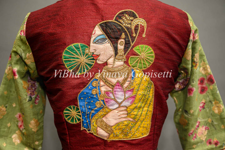 Maroon hand painted blouse with embroidery and floral sleeves.