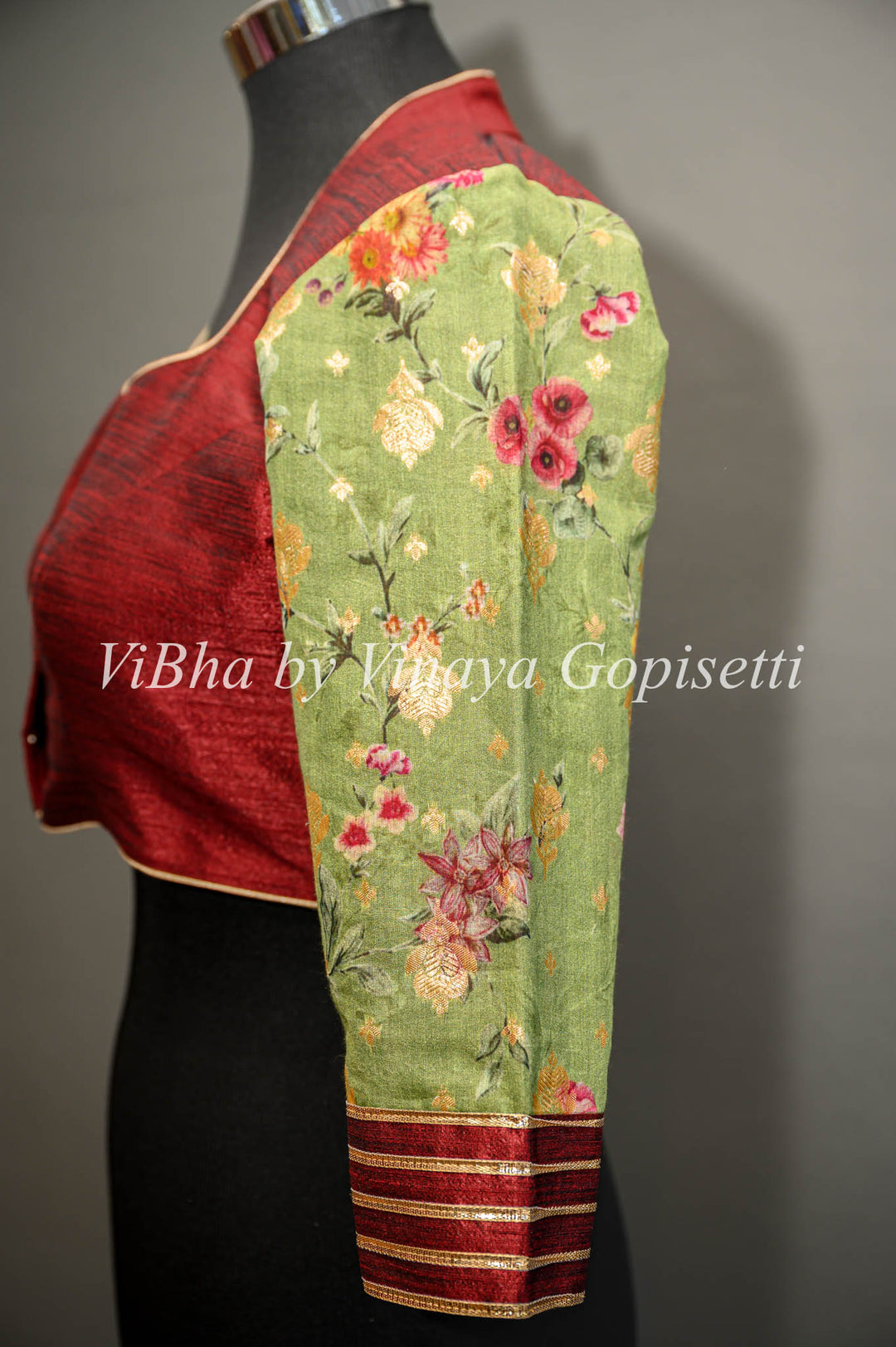 Maroon hand painted blouse with embroidery and floral sleeves.