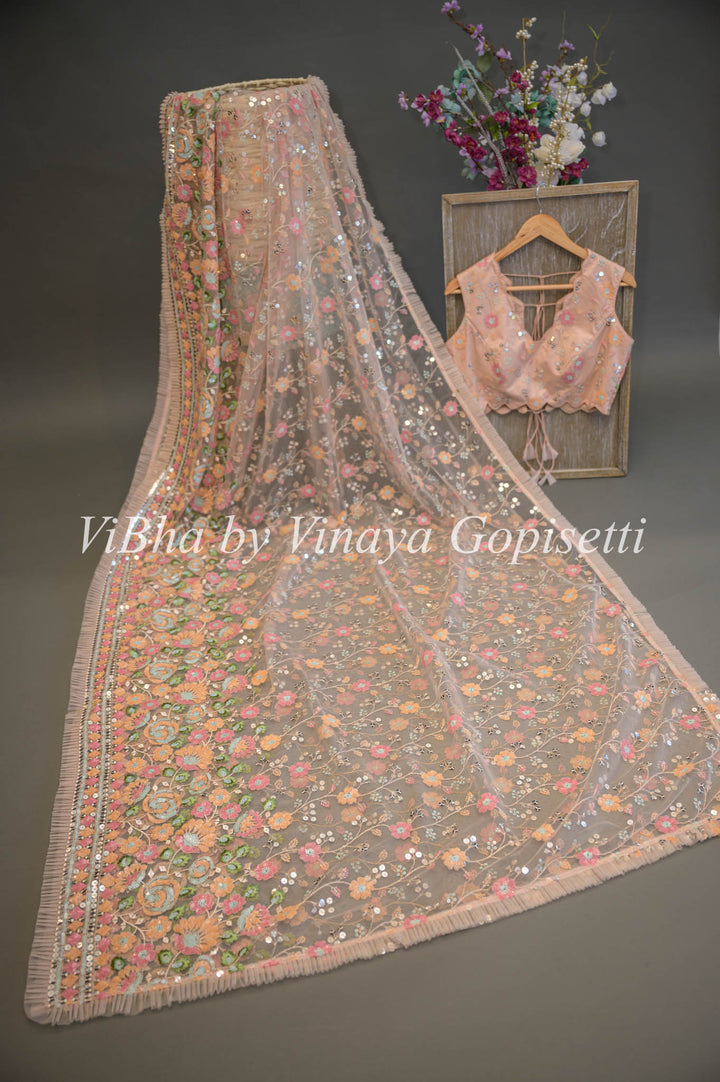 Pastel Peach Net Floral Embroidered Saree And Blouse