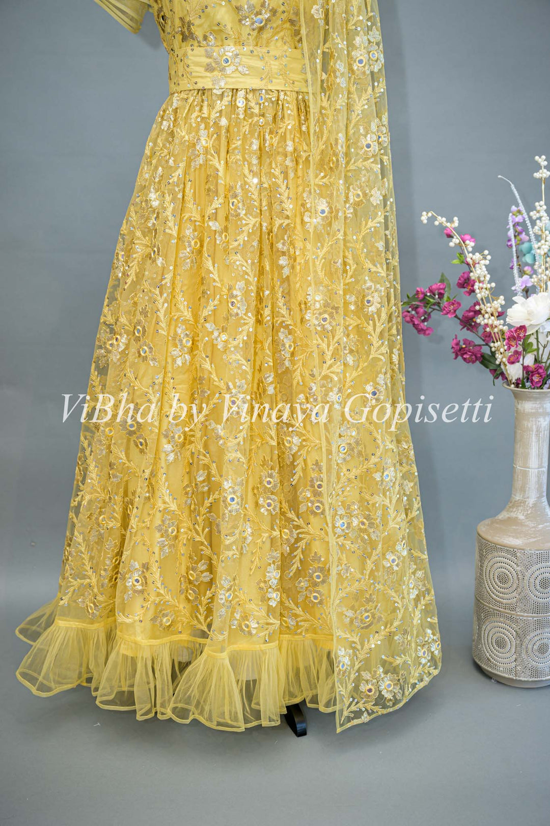 Yellow Net Embroidered One Side Cape Sleeve Gown