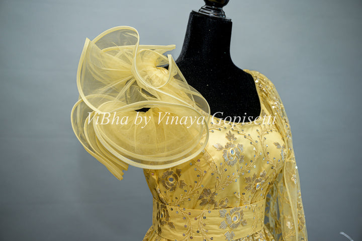 Yellow Net Embroidered One Side Cape Sleeve Gown