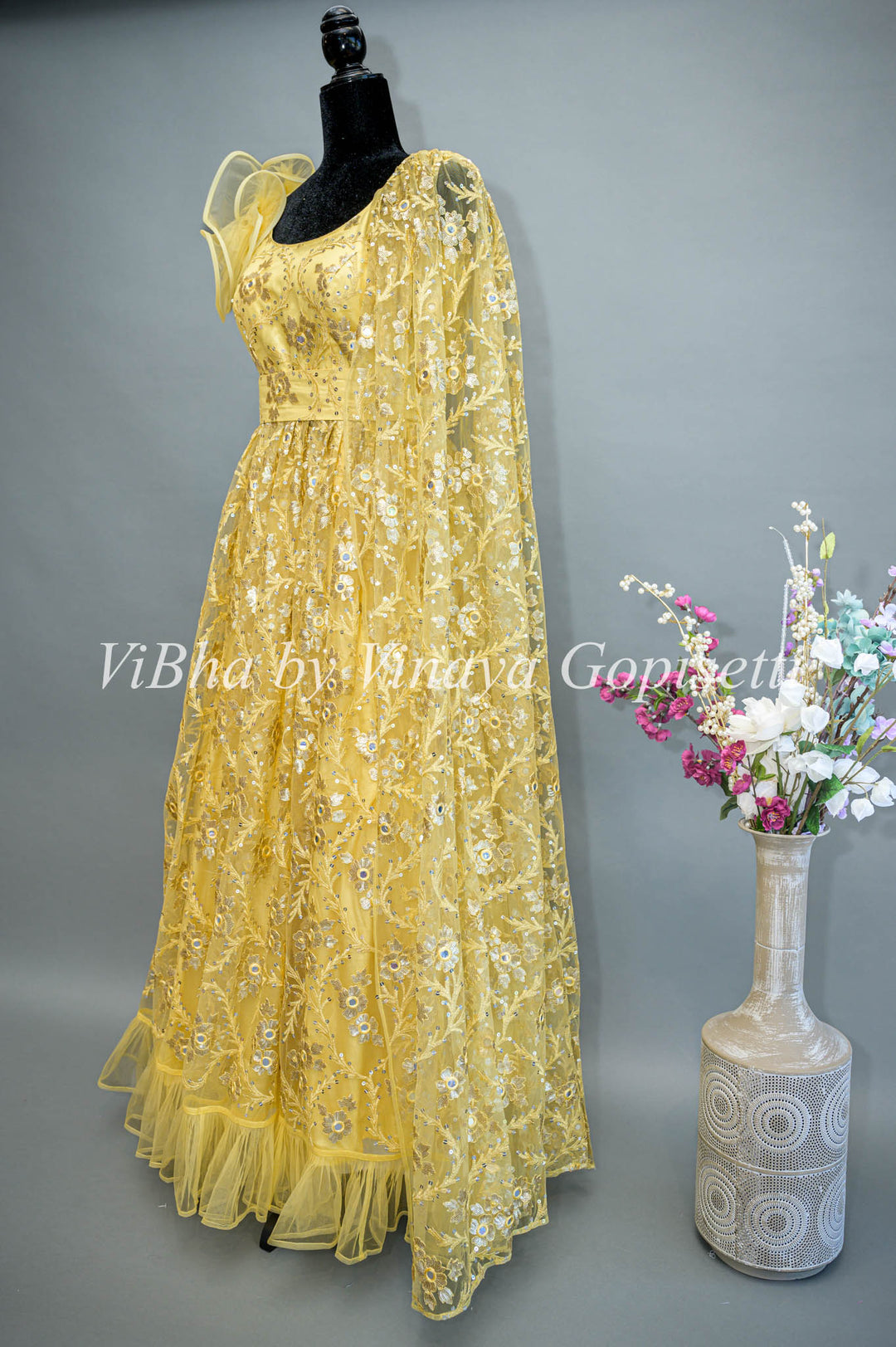 Yellow Net Embroidered One Side Cape Sleeve Gown