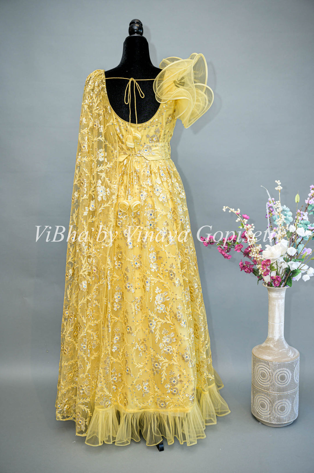 Yellow Net Embroidered One Side Cape Sleeve Gown