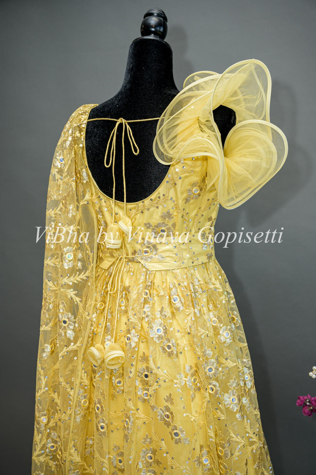 Yellow Net Embroidered One Side Cape Sleeve Gown