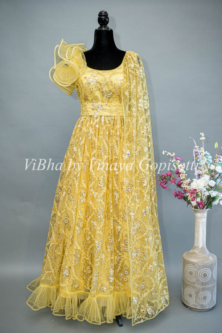 Yellow Net Embroidered One Side Cape Sleeve Gown