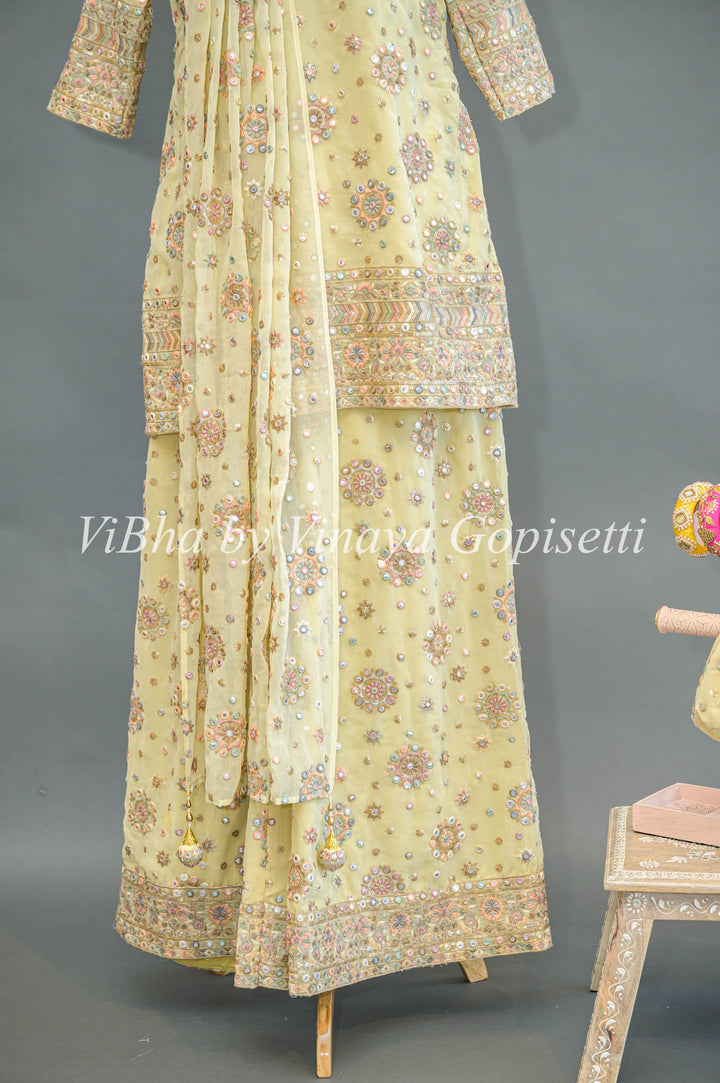 Pastel Yellow Embroidered Sharara Set With Choker Dupatta And Matching Potli Bag